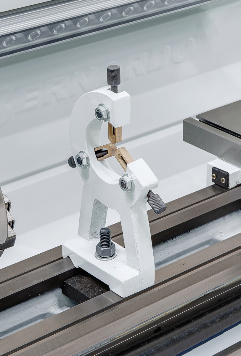 Steady rest with bronze guiding supports long workpieces. 